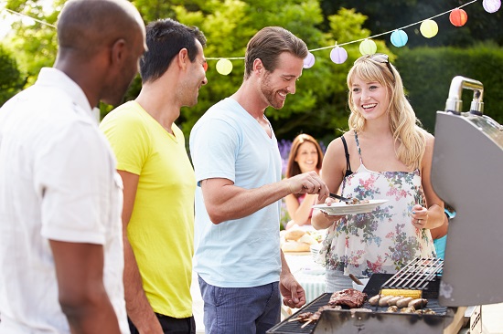 Group Of Friends Having Outdoor Barbeque At Home